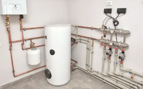 Nowoczesna instalacja grzewcza z zasobnikiem i kotłem. To rozwiązanie zapewnia najtańsze ogrzewanie mieszkania w kamienicy, minimalizując koszty.